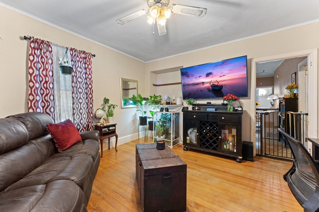 21 Russell Street Taunton, MA 02780 - Photo 6 of 42 a living room with furniture a fireplace and a chandelier