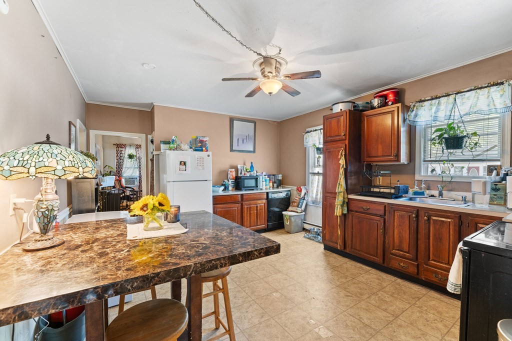 21 Russell Street Taunton, MA 02780 - Photo 9 of 42 a view of a dining room with furniture a kitchen and chandelier