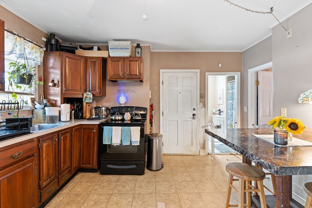 21 Russell Street Taunton, MA 02780 - Photo 10 of 42 a kitchen with stainless steel appliances a stove a sink and a refrigerator