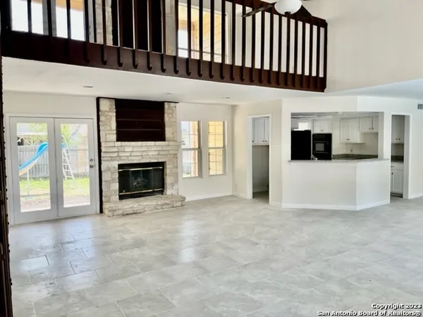 a view of a livingroom with an entryway and fire place