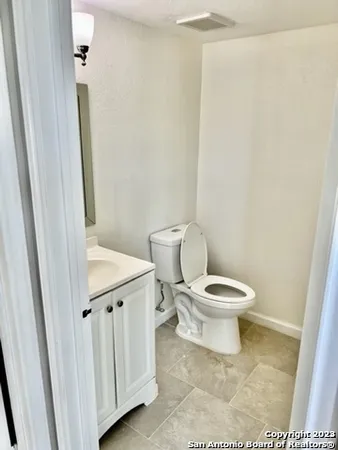 a white toilet sitting next to a white sink