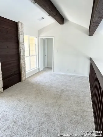 a view of an empty room with a fireplace