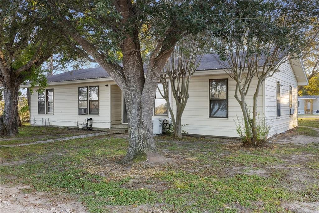 2361 Smetana Road Bryan, TX 77807 - Photo 25 of 32 a white house that has a tree in front of it
