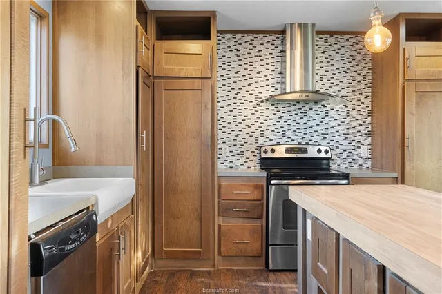 a large kitchen with a large window and stainless steel appliances