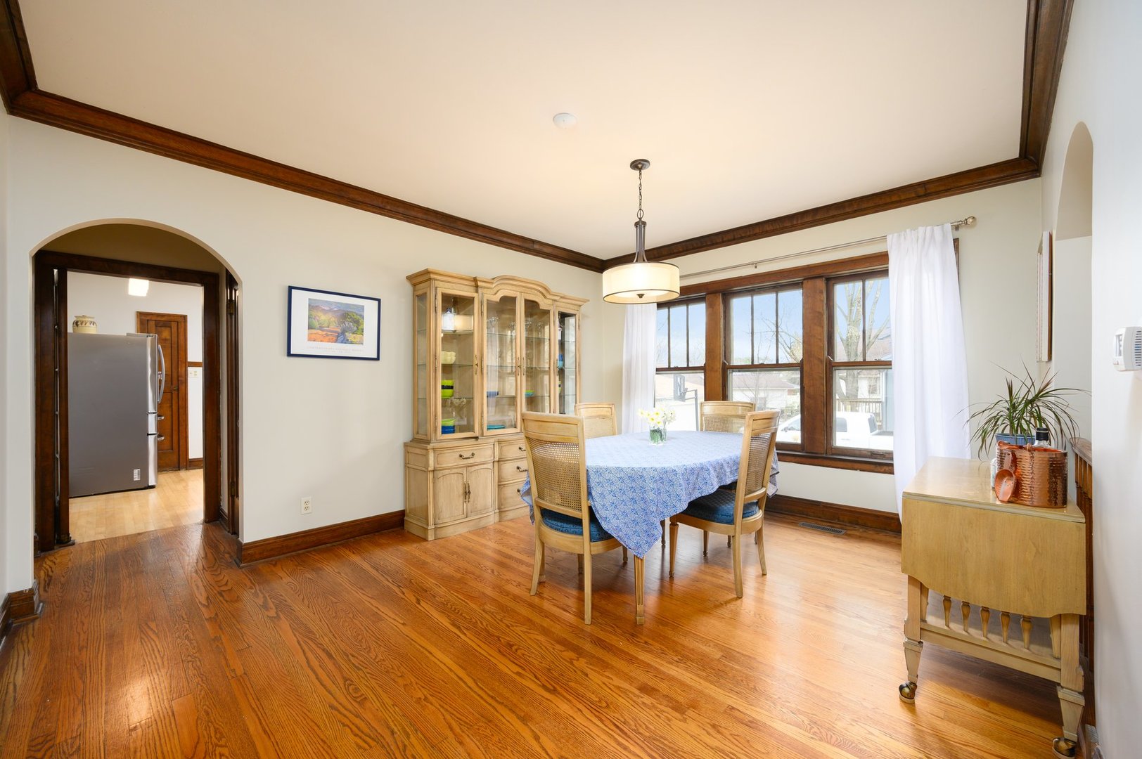 285 Nuttall Road Riverside, IL 60546 - Photo 9 of 27 a dining room with wooden floor a chandelier a wooden table and chairs