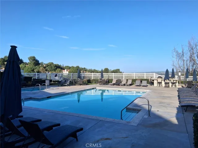 a living room with furniture and floor to ceiling windows