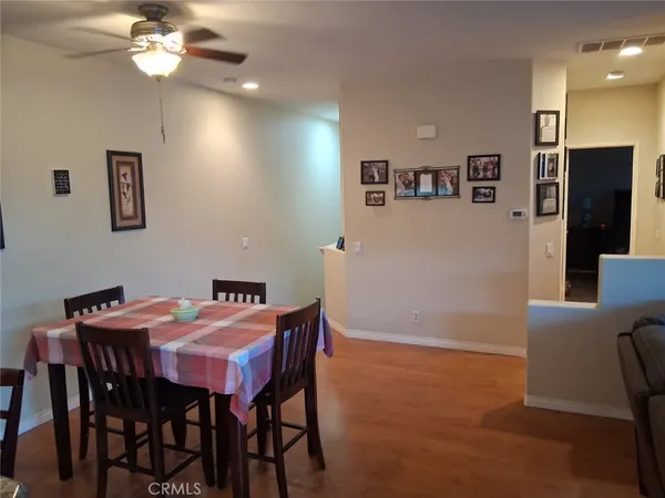 a kitchen with stainless steel appliances granite countertop a sink a table and chairs