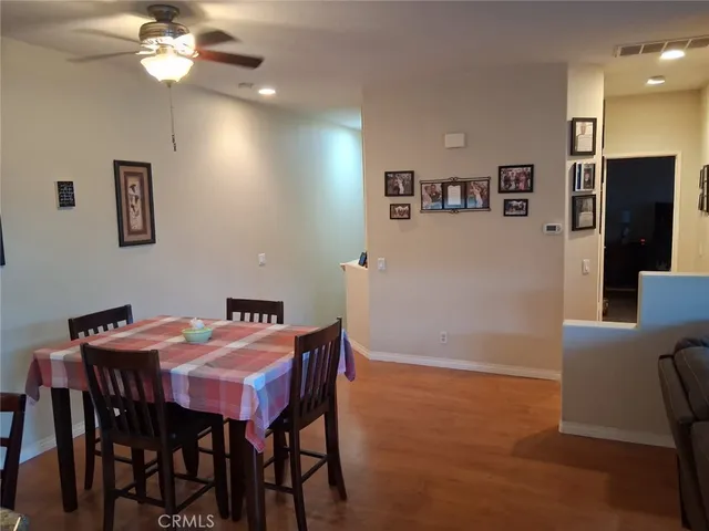 a kitchen with stainless steel appliances granite countertop a sink a table and chairs