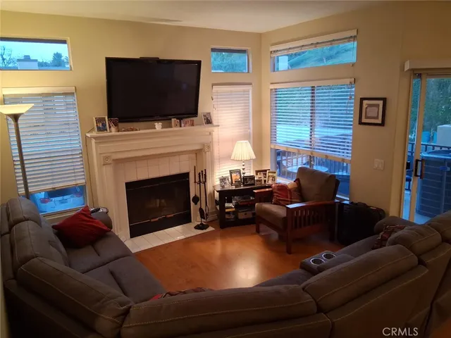 a living room with stainless steel appliances furniture windows and a view