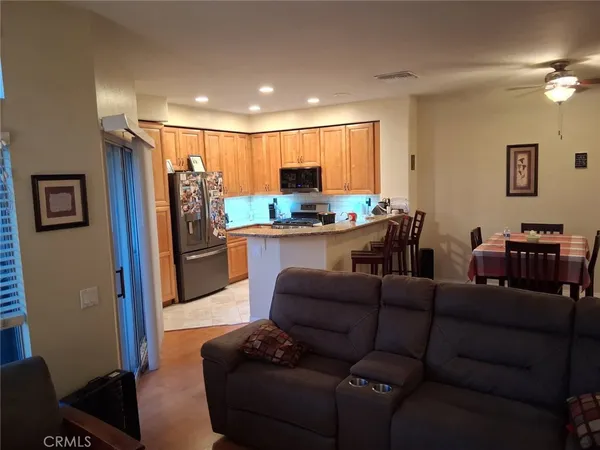 a view of a hallway with wooden floor and furniture