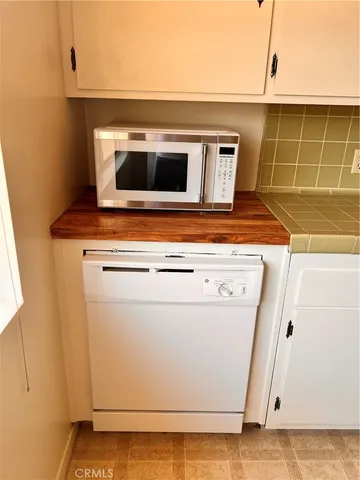 a stove top oven sitting inside of a kitchen