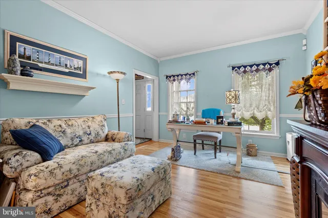 a living room with furniture and a painting on the wall