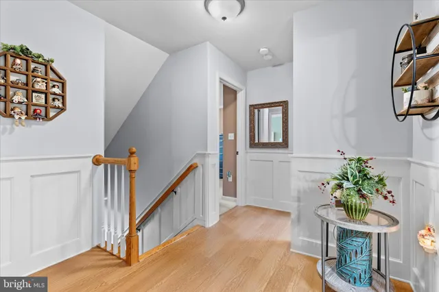 a spacious bedroom with a bed and a chandelier
