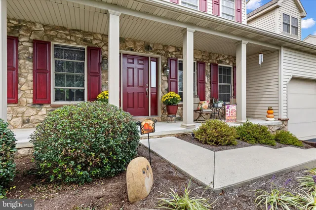 a view of a house with potted plants