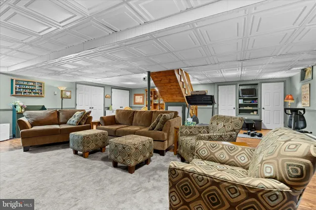 a living room with furniture and a floor to ceiling window