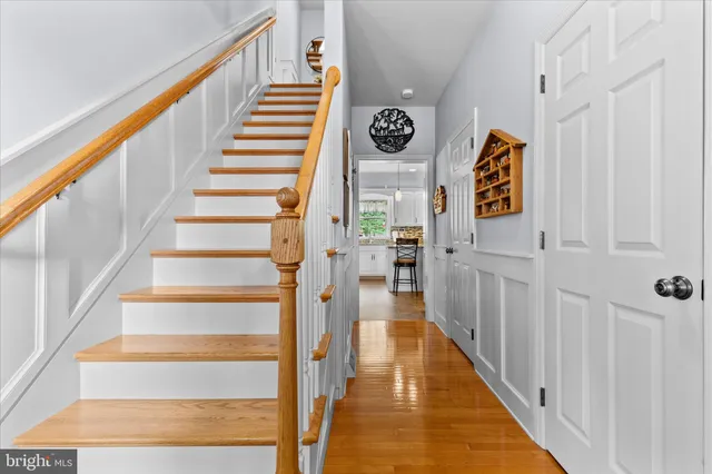 a view of entryway and hall with wooden floor