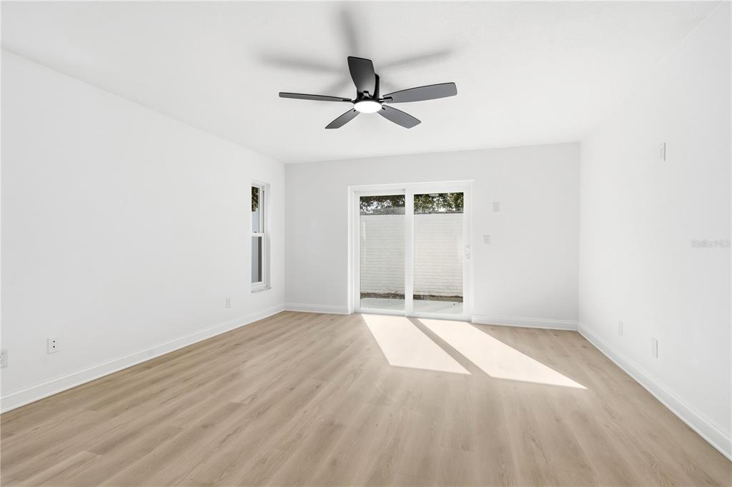 1985 Japonica Road Winter Park, FL 32792 - Photo 25 of 51 an empty room with wooden floor chandelier fan and windows