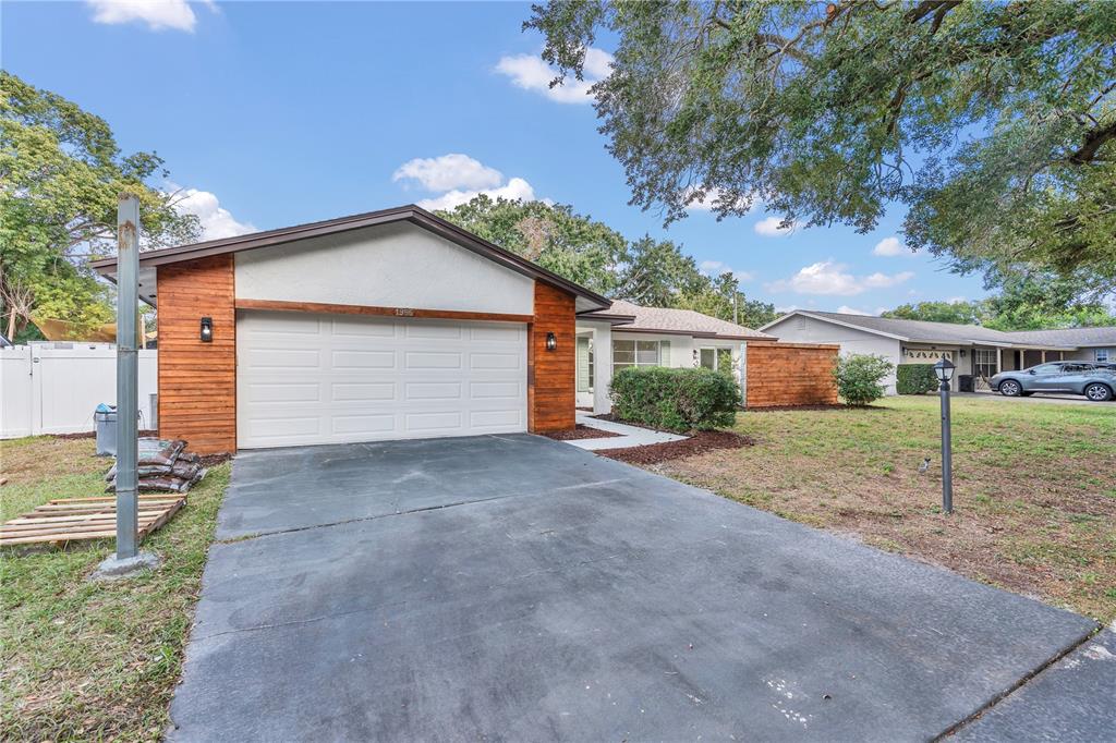 1985 Japonica Road Winter Park, FL 32792 - Photo 3 of 51 a view of a house with a yard and garage
