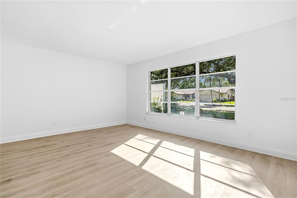 1985 Japonica Road Winter Park, FL 32792 - Photo 31 of 51 an empty room with wooden floor and windows