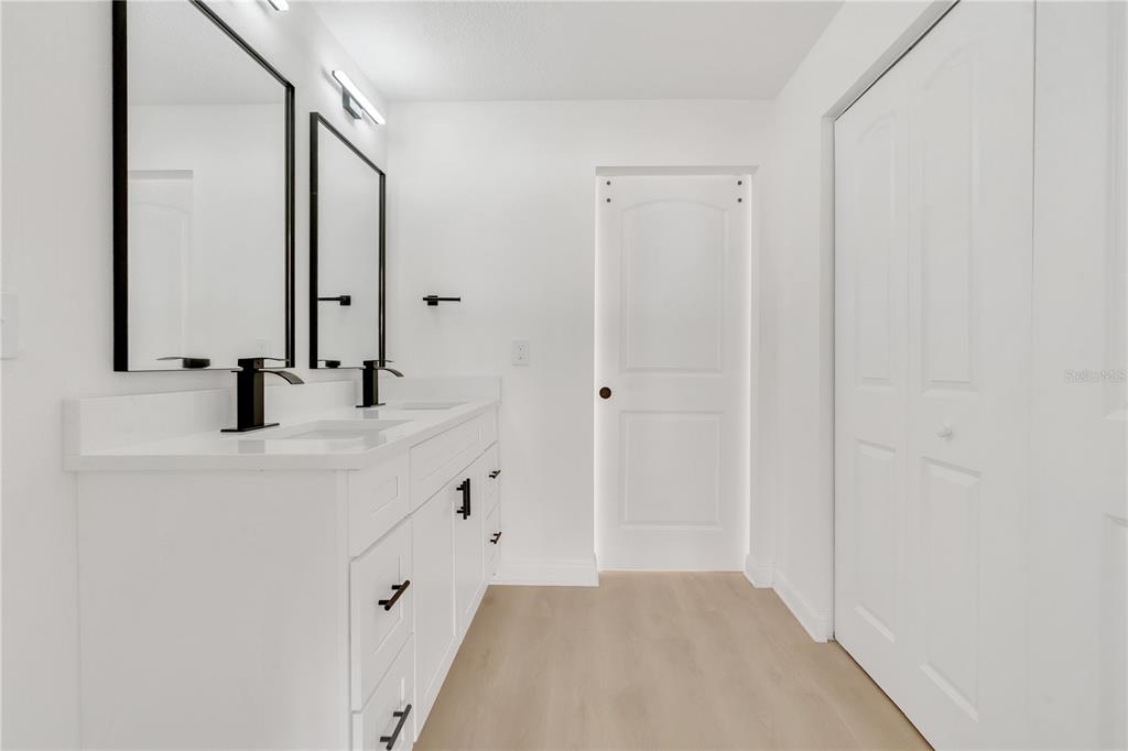 1985 Japonica Road Winter Park, FL 32792 - Photo 34 of 51 a bathroom with a double vanity sink and mirror