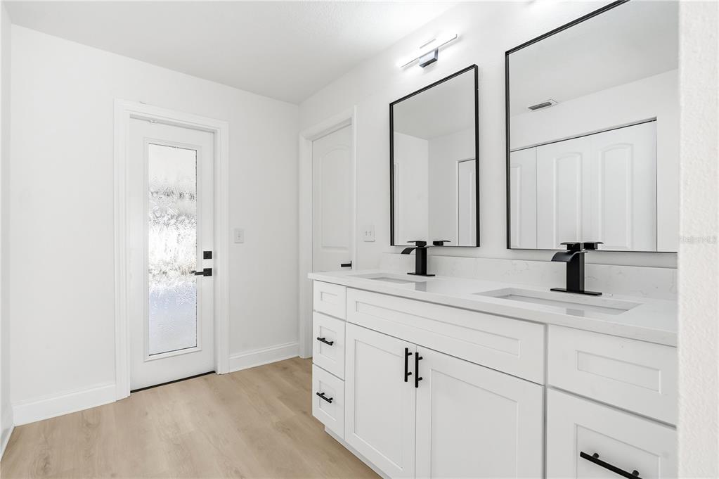 1985 Japonica Road Winter Park, FL 32792 - Photo 35 of 51 a bathroom with a double vanity sink and mirror