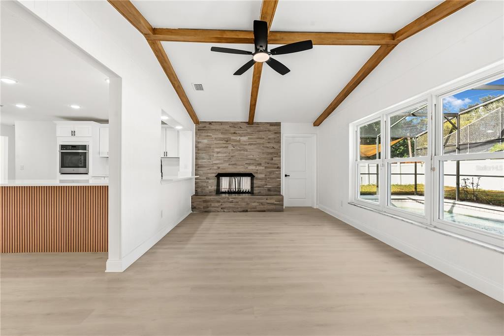 1985 Japonica Road Winter Park, FL 32792 - Photo 9 of 51 a view of an empty room with a fireplace and a window