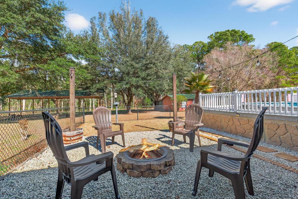 2744 Roy Sikes Road Hilliard, FL 32046 - Photo 70 of 97 a view of a chair and tables in the patio