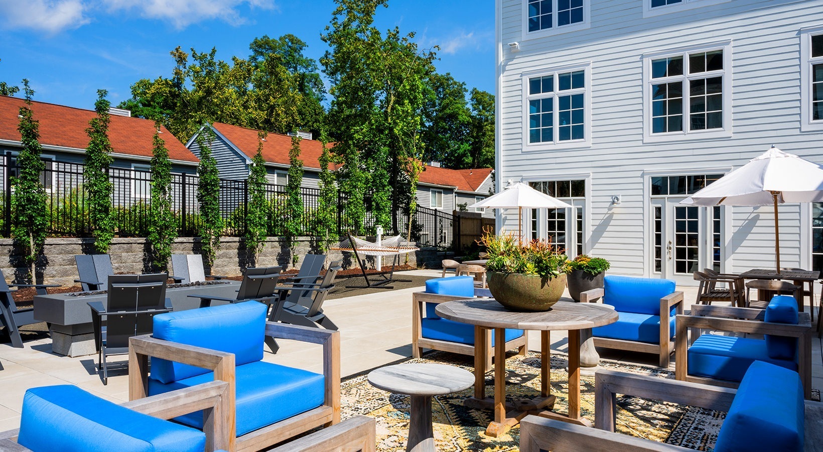 333 Unquowa Road, Unit 324 Fairfield, CT 06824 - Photo 9 of 12 a view of a patio with dining table and chairs with plants