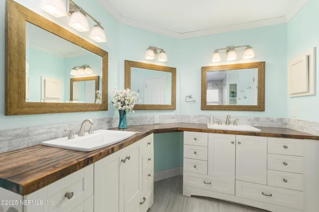 a bathroom with double sink and a mirror
