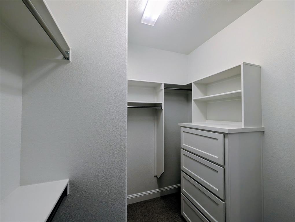 15532 Fringe Tree Road Frisco, TX 75035 - Photo 8 of 31 Walk-in closet featuring custom built-in cabinetry with drawer storage, integrated shelving, hanging rods, and recessed lighting