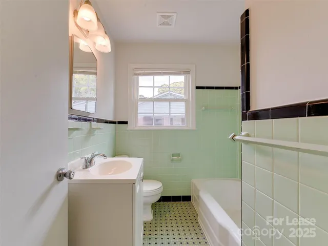 a bathroom with a sink a toilet and window