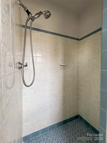 a bathroom with a shower and a shower head