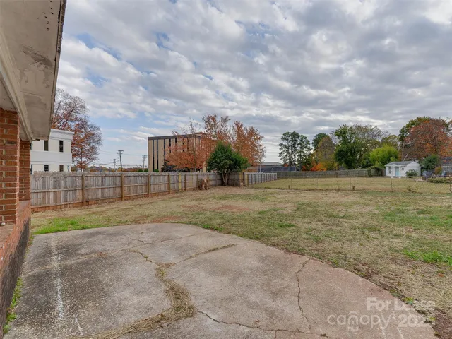 a view of a house with a big yard and potted plants