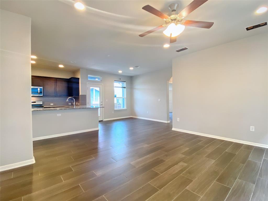 8901 Panhandle Drive Austin, TX 78747 - Photo 6 of 21 Open-concept living area featuring wood-finish flooring, a contemporary ceiling fan, and recessed lighting