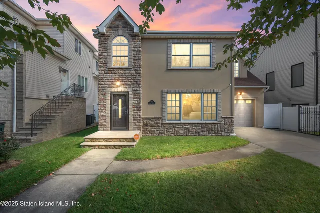 a front view of a house with a yard