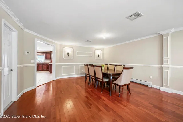 a dining room with furniture and wooden floor