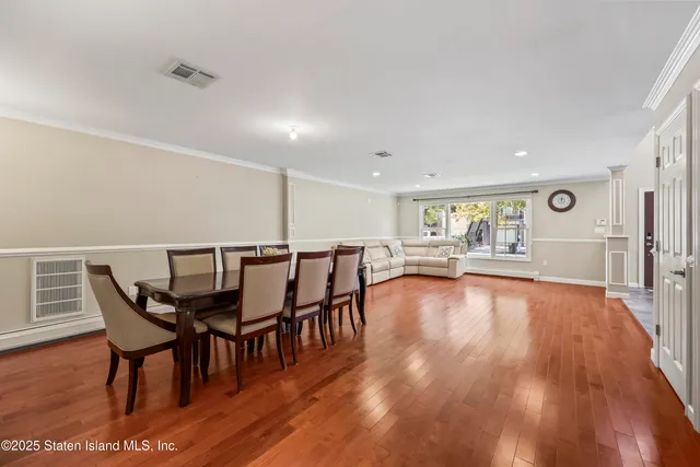 a dining room with furniture and wooden floor