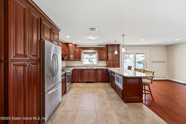 a large kitchen with a table and chairs