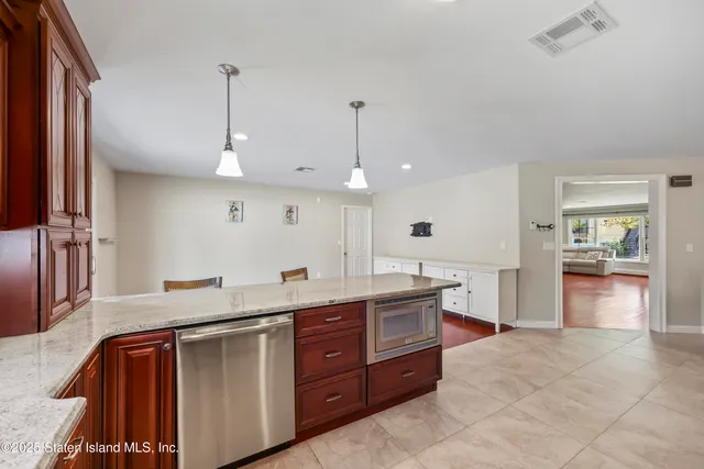 a kitchen with granite countertop a sink and cabinets