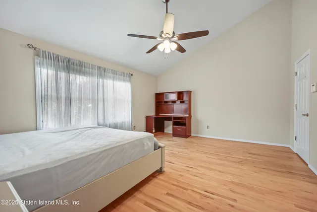 a bedroom with bed and a chandelier