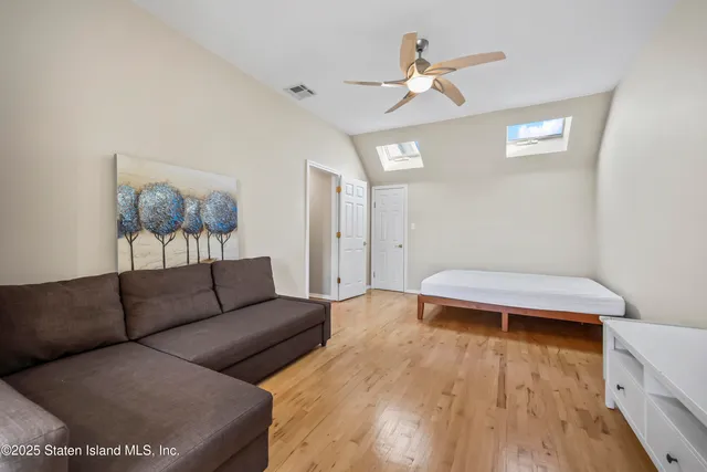 a view of a bedroom with a bed and a window