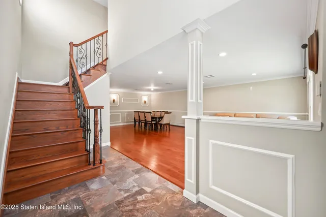 a view of entryway and hall with wooden floor