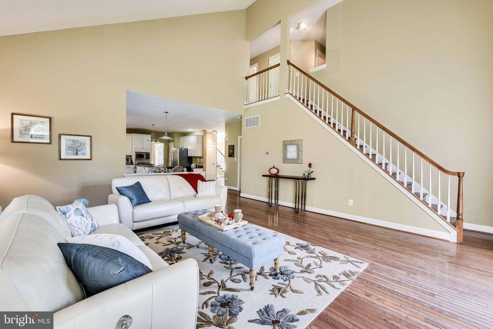 1701 Raleigh Hill Road Vienna, VA 22182 - Photo 12 of 61 a living room with couches and a dining table with wooden floor
