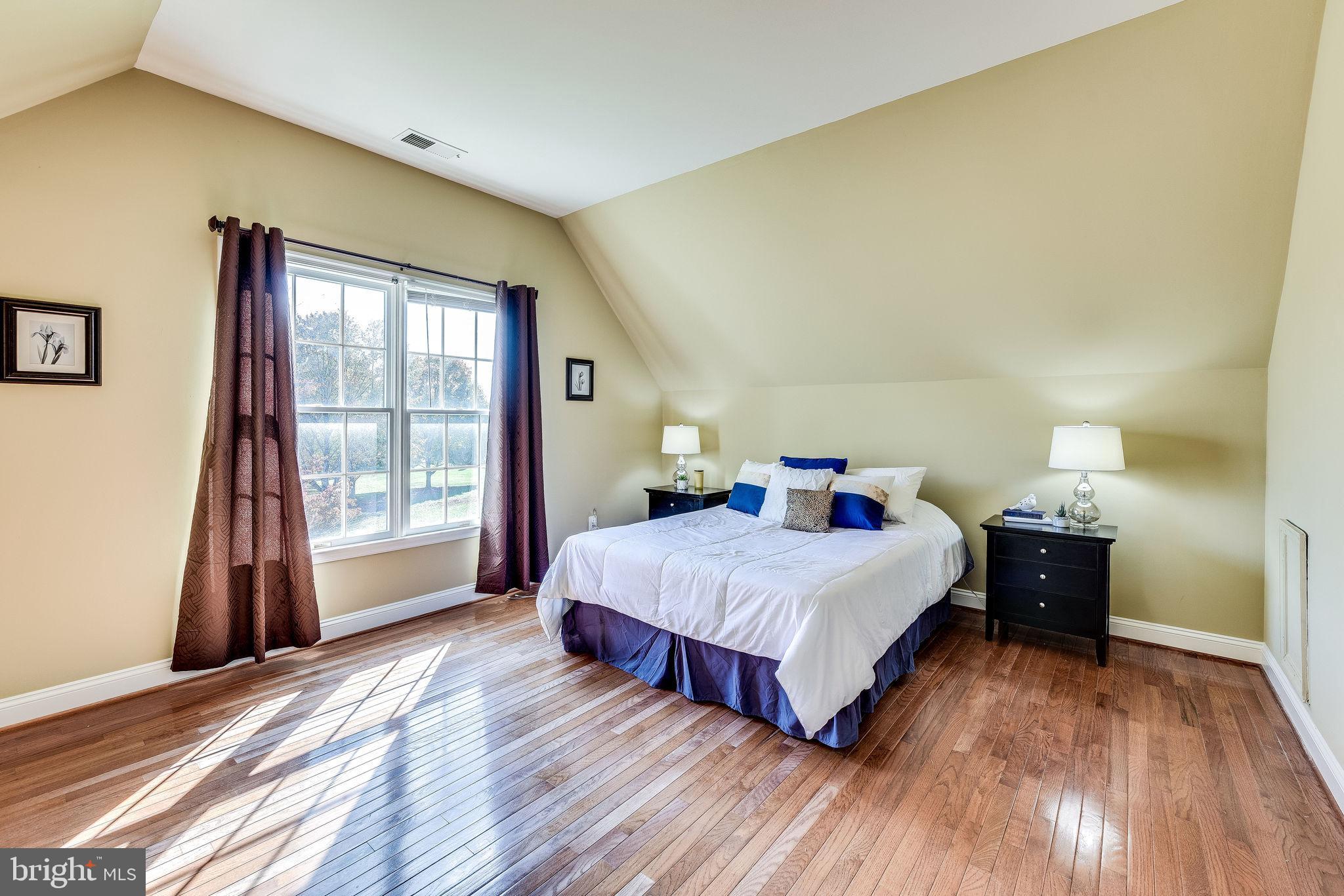 1701 Raleigh Hill Road Vienna, VA 22182 - Photo 37 of 61 a bedroom with a bed and wooden floor