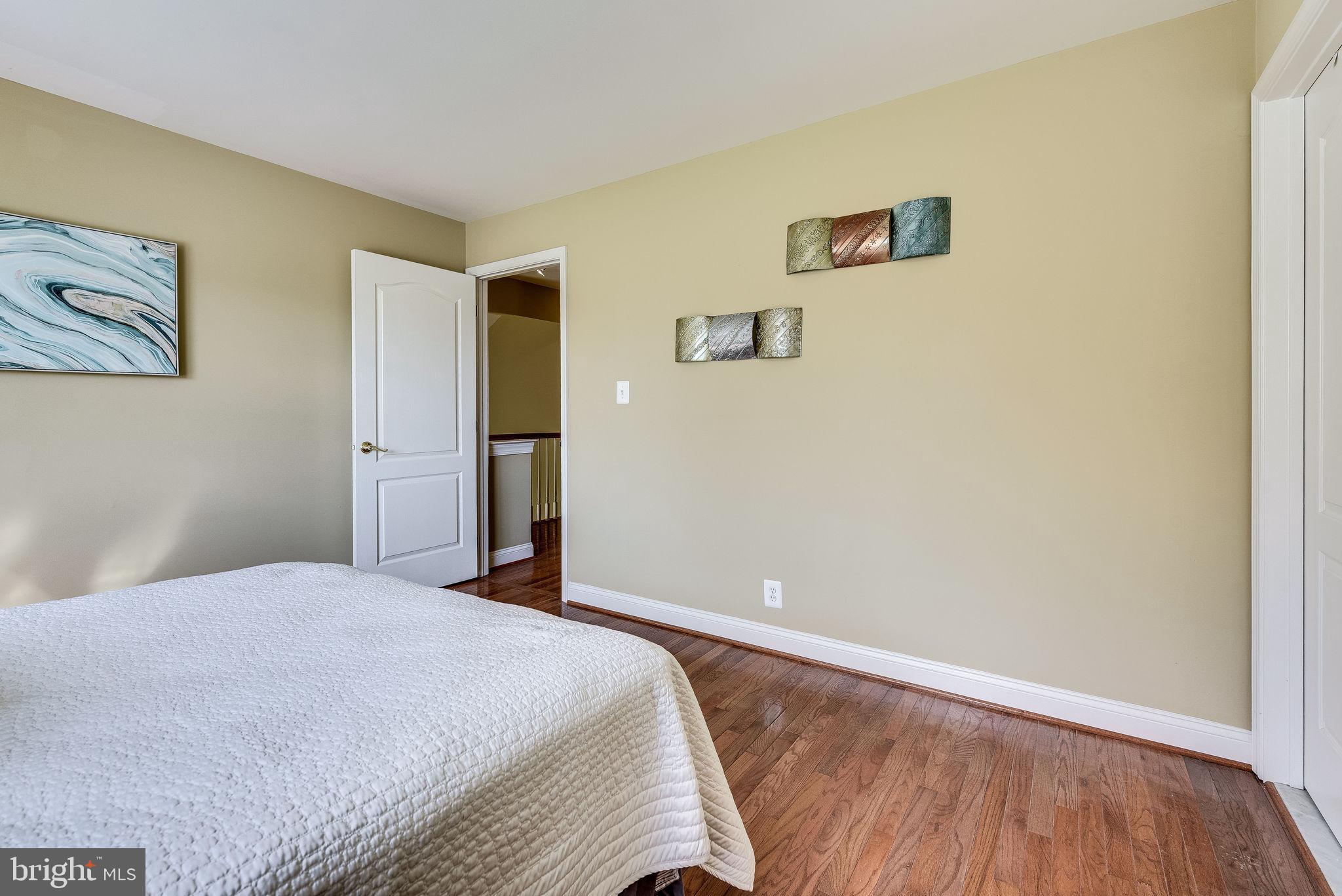 1701 Raleigh Hill Road Vienna, VA 22182 - Photo 42 of 61 a bedroom with a bed and wooden floor