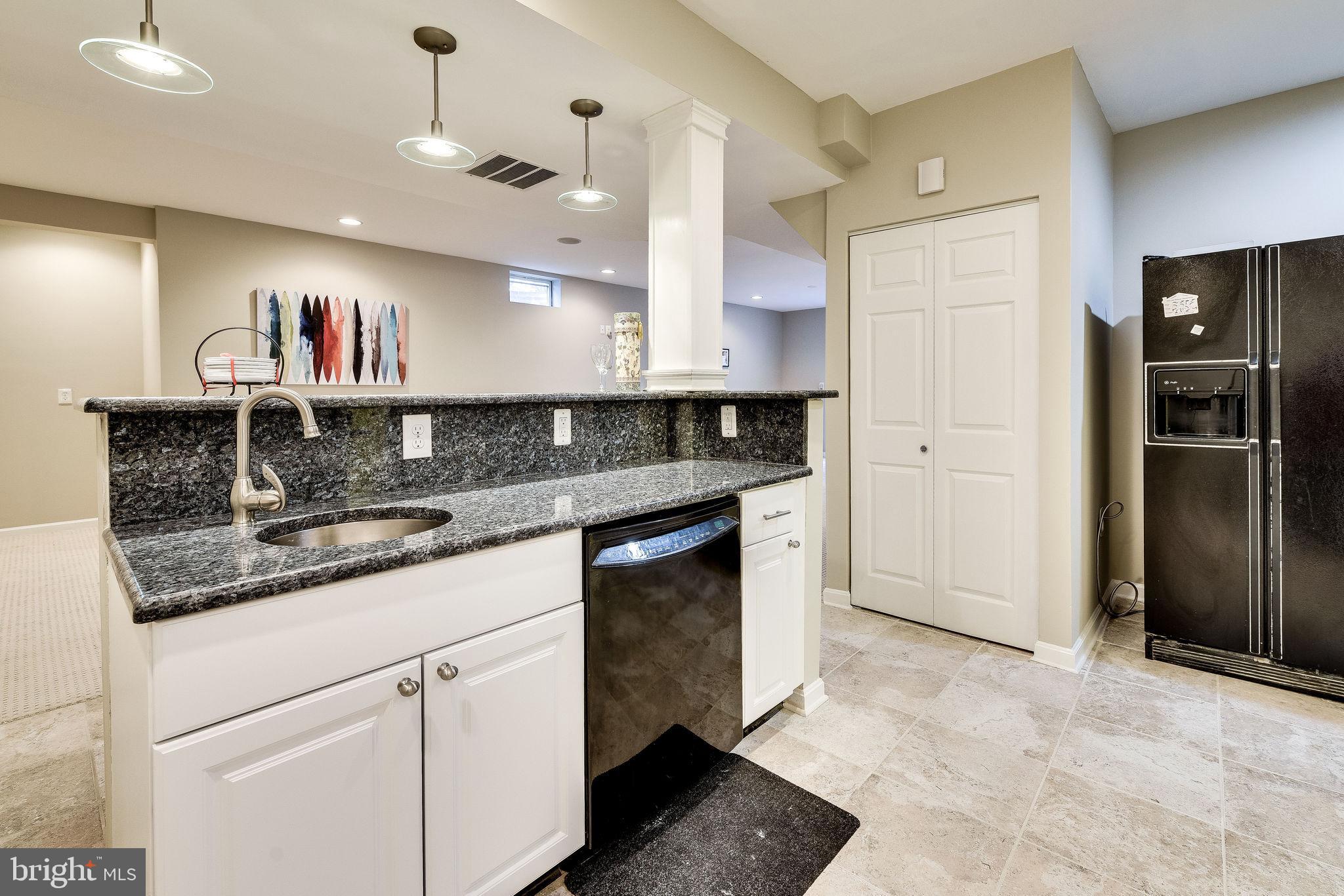 1701 Raleigh Hill Road Vienna, VA 22182 - Photo 51 of 61 a kitchen with stainless steel appliances granite countertop a refrigerator a sink and a stove