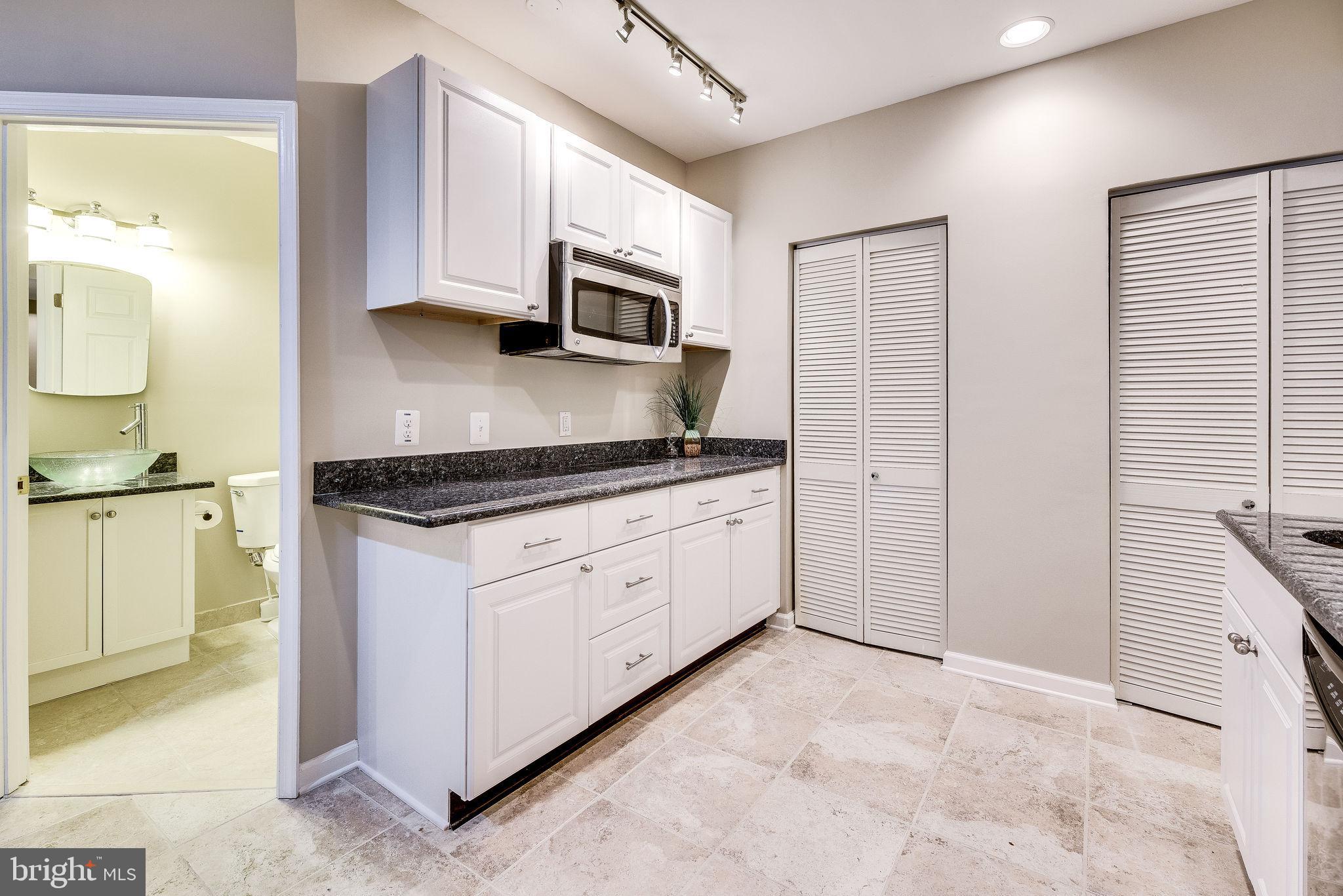 1701 Raleigh Hill Road Vienna, VA 22182 - Photo 52 of 61 a kitchen with stainless steel appliances granite countertop white cabinets and window