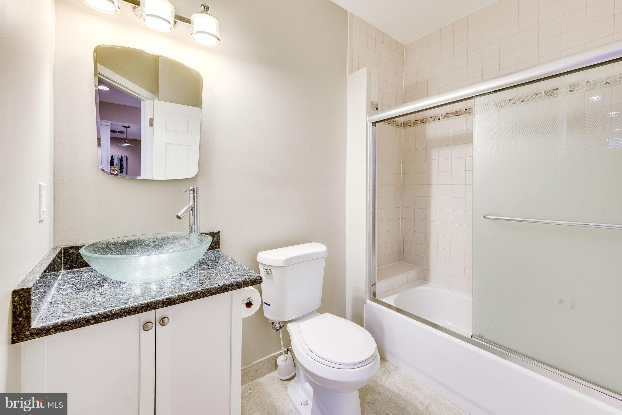 1701 Raleigh Hill Road Vienna, VA 22182 - Photo 57 of 61 a bathroom with a granite countertop sink mirror vanity and toilet