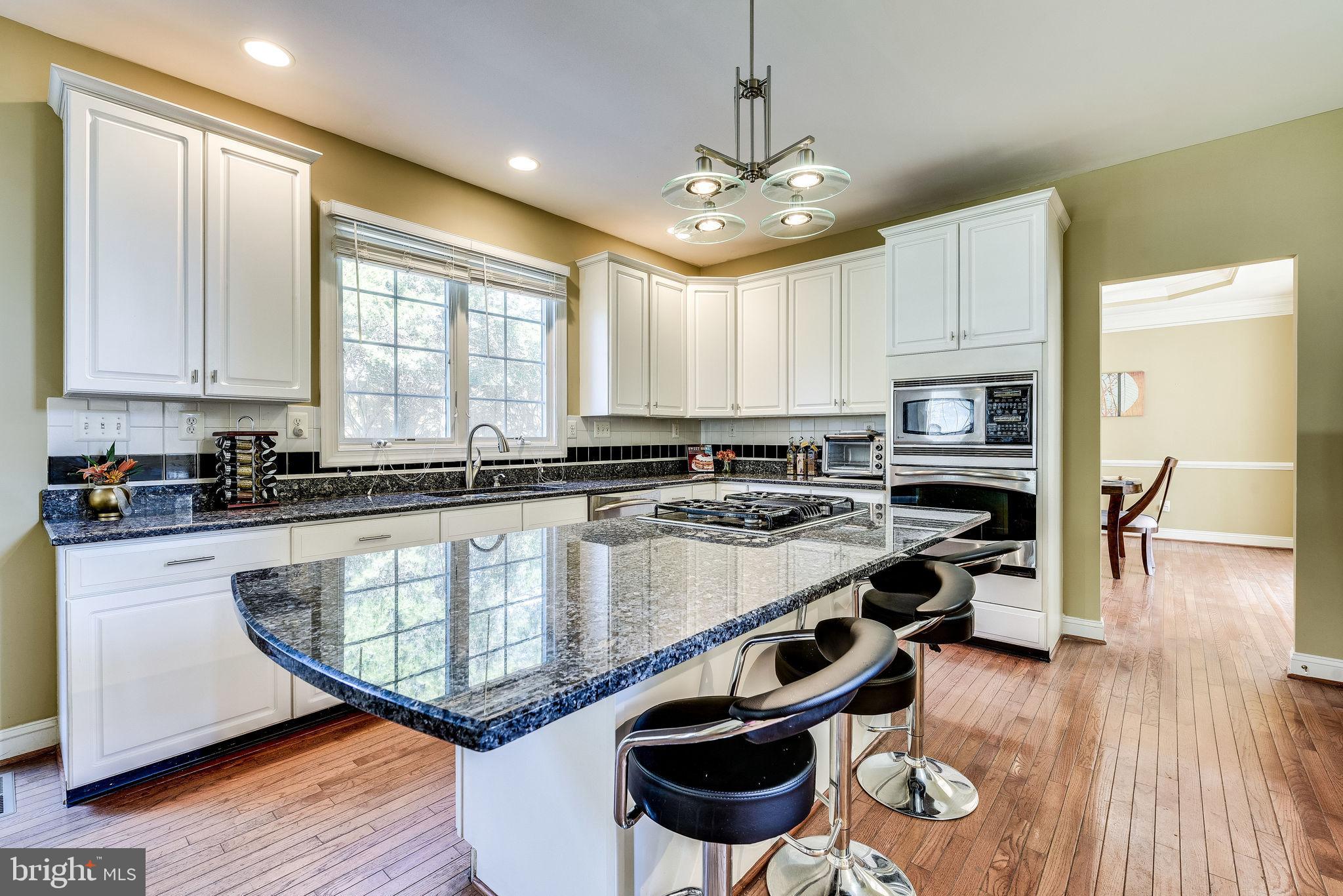 1701 Raleigh Hill Road Vienna, VA 22182 - Photo 7 of 61 a large kitchen with stainless steel appliances granite countertop a stove and a wooden floors