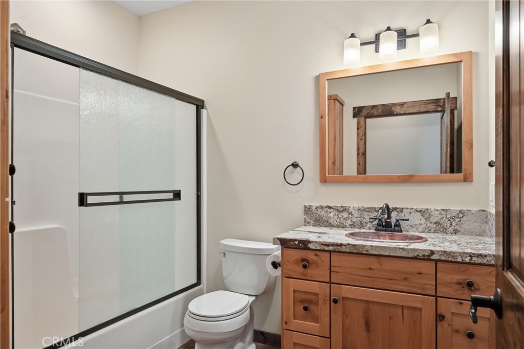 21060 Santa Clara Road Middletown, CA 95461 - Photo 10 of 21 a bathroom with a granite countertop sink vanity mirror and toilet